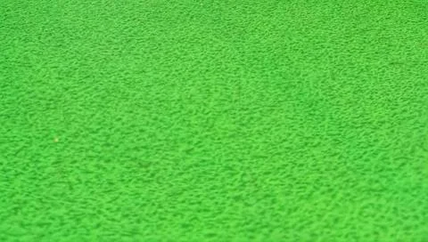 Vibrant green surface with textured pattern fills the frame, creating an abst 스톡 사진
