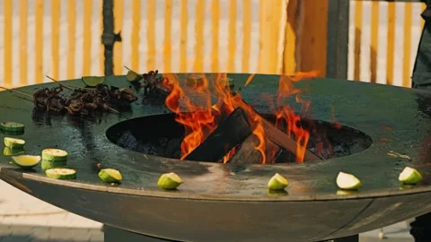 A vibrant grill with dancing flames and sizzling shrimp skewers surrounded Stock Footage 319446591
