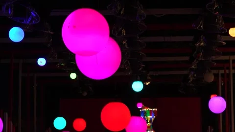 Vibrant Hanging Neon Orb Lights in Pink and Blue Stock Footage 324945465
