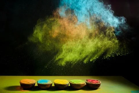 Vibrant holi color powder exploding from bowls Stock Photos