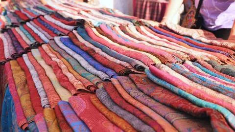 Vibrant Indian textile patterns creating a colorful display at a Moscow market Stock Photos
