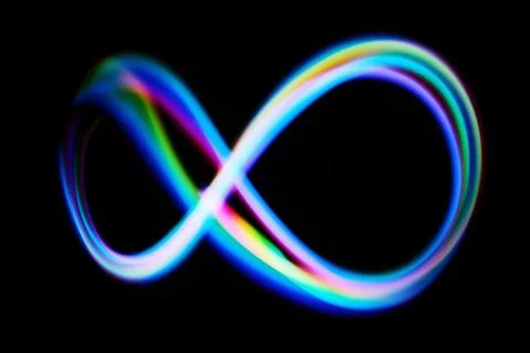 Vibrant Infinity Loop. A colorful neon infinity loop glows against a black Stock Photos