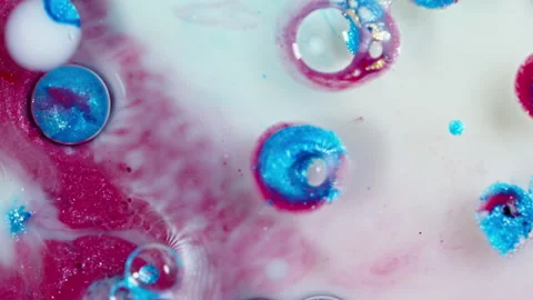 Vibrant ink droplets diffusing in water, creating abstract swirls of pink Video stock 269258490