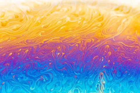 Vibrant iridescent soap bubble surface with swirling patterns of yellow, pu.. Illustrazione stock