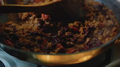 Vibrant kitchen view: simmering a rich burrito filling Stock Footage 342167570