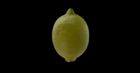 A vibrant lemon gracefully orbits against a dark. Stock Footage 300498969