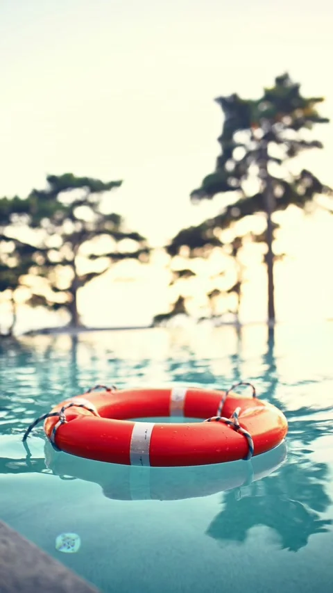 Vibrant Lifebuoy Floating On Pool At Sunset. Stock Footage 314392907