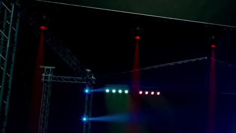 Vibrant Lights Illuminating a Dynamic Stage Setup at a Music Event Stock Footage 347057625