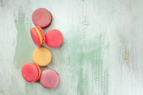 Vibrant macarons on light teal texture with copyspace 스톡 사진