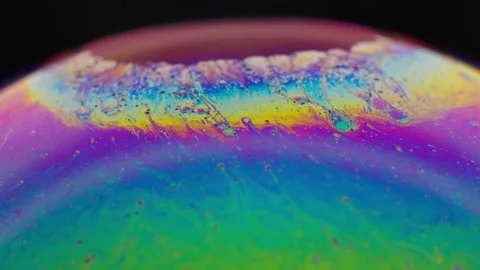 A vibrant macro shot of a bubble surface displaying a stunning array of 動画素材 281194758