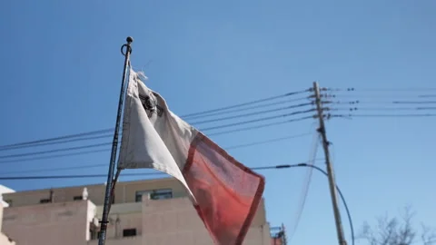 Vibrant Maltese flag waving dynamically in the clear foreground. Stock Footage 315590347