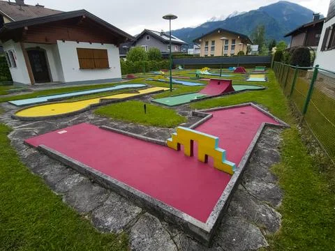A vibrant mini golf course featuring colorful obstacles and beautiful mount.. Stock Photos
