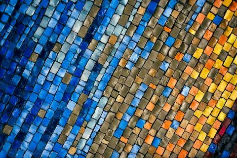 Vibrant mosaic wall with dynamic wave pattern in orange and blue tones Stock Photos