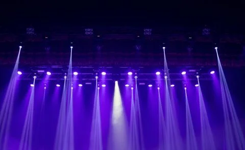 Vibrant multi colored beams of stage lighting cross through concert haze, cre Foto stock