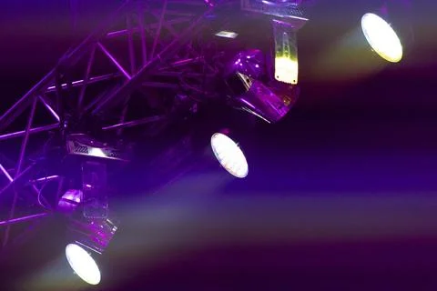 Vibrant multi colored beams of stage lighting cross through concert haze, cre Foto stock