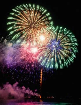 Vibrant multi colored fireworks exploding against a pure black background. Stock Photos