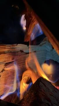 Vibrant multi-colored flames in hues of bright blue, purple, and golden orange Stock Photos