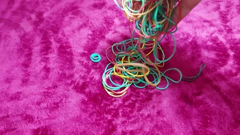 Vibrant Multi-Colored Rubber Bands in Action 스톡 동영상 303722779