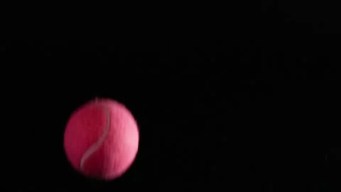 Vibrant Multi-Colored Tennis Balls Bouncing Against a Solid Black Background Stock Footage 327831963