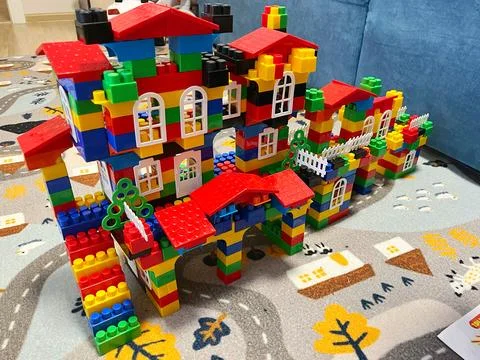 Vibrant multi-level house built from colorful plastic blocks. Stock Photos