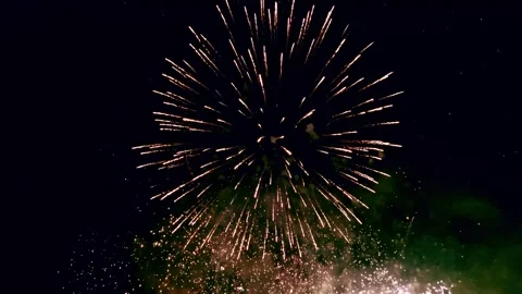 Vibrant multi tier fireworks lighting up the night sky with golden sparks Stock Footage 319523683