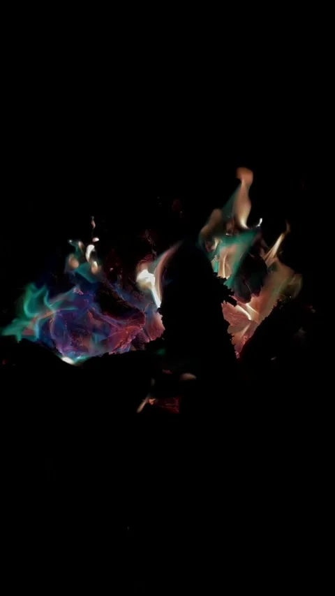 Vibrant multicolored flames and smoke swirling on dark black studio background Stock Footage 346558374