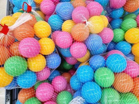 Vibrant Multicolored Plastic Balls in Mesh Bags - Playful Abundance Stock Photos