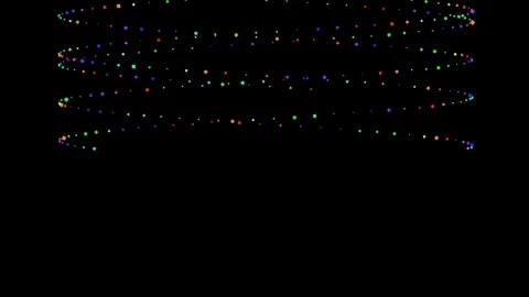 Vibrant multicolored string lights glowing against a deep black background Video stock 335117580