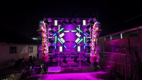 Vibrant Neon Carnival Stage Lighting Under Night Sky Stock Footage 345158804