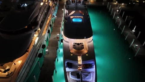 Vibrant Night Aerial of Multi-Million Dollar Yachts Near Atlantis Bahamas Stock Footage 295802716