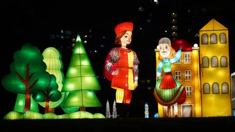Vibrant Night Lantern Display with Figures and Trees Stock Photos