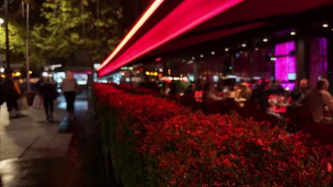 A Vibrant Night Scene Captured with Bright Neon Lights and Lively Urban Activity Stock Footage 318554859