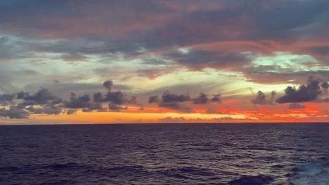 Vibrant ocean sunset with colorful clouds and serene water Stock Footage 338280023