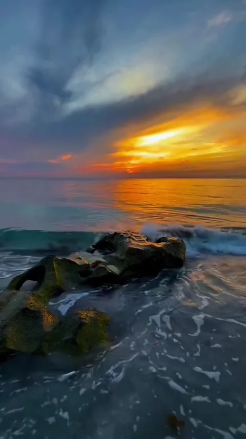 Vibrant Ocean Sunset Over Rocky Shoreline Video stock 343557518