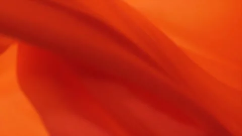 Vibrant orange abstract art showcasing flowing fabric textures 스톡 동영상 320390549