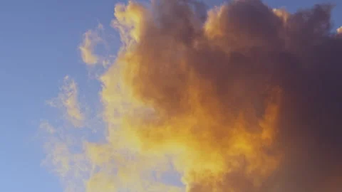 Vibrant Orange Cloud Against Clear Blue Sky Stock Footage 275690329