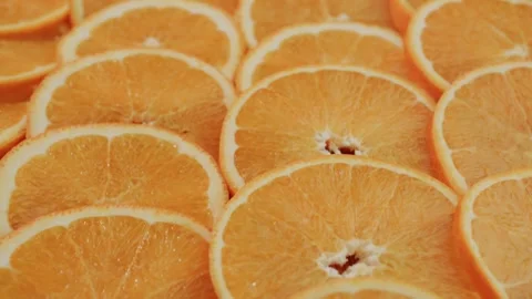 Vibrant orange fruit slices background with slow camera movement over fresh.. Stock Footage 334993005