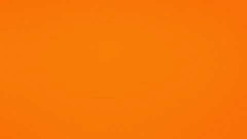 Vibrant orange seamless loop background with soft grain texture, 4K. Stock Footage 309855760
