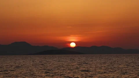 Vibrant Orange Sun Setting Over Aegean Sea Mountains in Bodrum 4K 動画素材 344057070