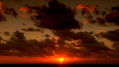 Vibrant orange sunset. Clouds and ocean waves view from beach. static Stock Footage 102532293