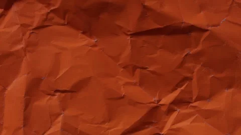 Vibrant orange wrinkled paper texture seamless loop. Warm stop-motion animati Stock Footage 335894892
