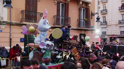 Vibrant parade float with giant cartoon mice, adorned with flowers and lollipops Stock Footage 319883948