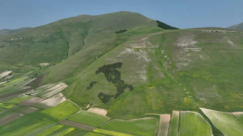 Vibrant Patchwork Fields Beneath Rolling Green Hills and Natural Italy Stock Footage 313961400