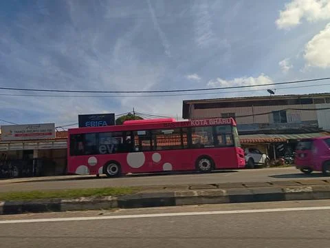 A vibrant pink bus Stock Photos