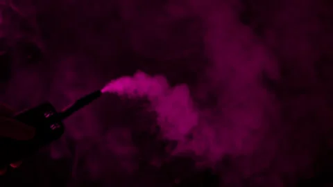 Vibrant pink smoke billows from a device in dark atmosphere Stock Footage 340264484