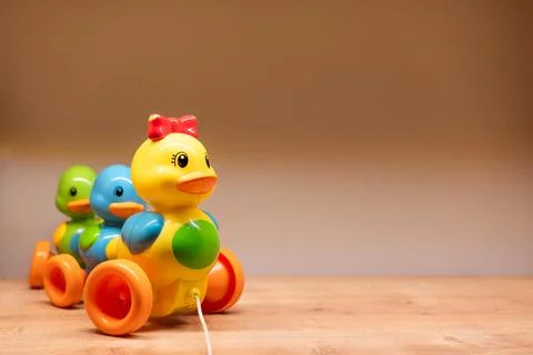 Vibrant Plastic Pull Toy Duck with Two Small Ducks on Wheels. Concept of playful Stock Photos
