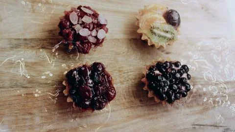 Vibrant plating process view: revealing glossy fruit over pastry cream Stock Photos