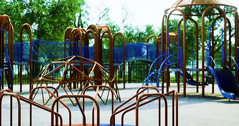 A vibrant playground filled with colorful structures stands in a sunlit park Stock Footage 318069153