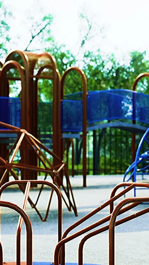 A vibrant playground filled with colorful structures stands in a sunlit park Stock Footage 320303060