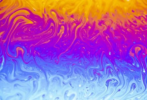 Vibrant psychedelic swirls of soap bubble iridescence in bright neon colors 스톡 사진